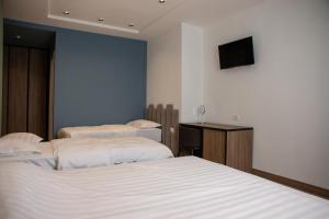 Letto o letti in una camera di Hotel Blini