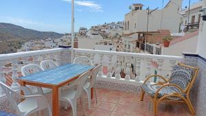 a table and chairs on a balcony with a view at Casa Liébana in Torrox