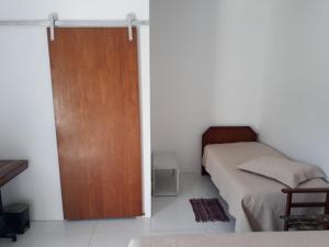 Postel nebo postele na pokoji v ubytování Recanto da Preguiça - Suites