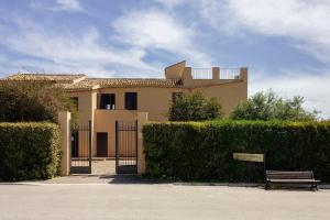 a house with a gate and a bench in front of it at Mid Modern Akragas Home in Center with Sea View in Agrigento