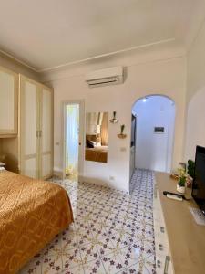 a bedroom with a bed and a room with a bed sqor at Central Studio Capri in Capri
