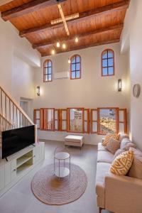 a living room with a couch and a tv at Casa Della vita Loft ,Rhodes Old town in Rhodes Town