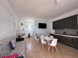 a kitchen and living room with a table and chairs at Villa Santo Stefano in Monopoli