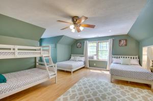 a room with two bunk beds and a ceiling fan at Massanutten Home Rental with Sauna and Game Room! in McGaheysville