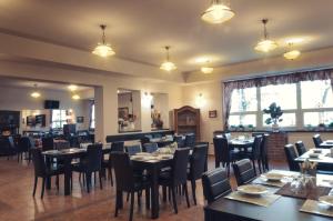 a restaurant with tables and chairs in a room at Chatová osada Na Skalkách in Nový Jičín