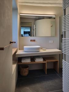 a bathroom with a sink and a mirror at La BouganVilla in Portovenere