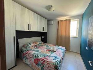 a bedroom with a bed with a colorful comforter at Lovely 3 Bedroom Condo in St. Julianʼs