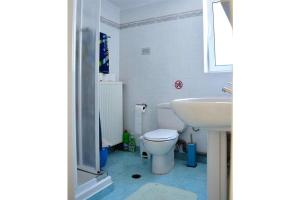 a bathroom with a white toilet and a sink at Blue View of Korinthian bay villa in Lecheo in Lékhaion