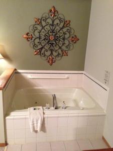 a bath tub with a sink and a towel at High Point Inn in Ephraim