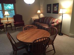 a living room with a couch and a table and chairs at High Point Inn in Ephraim