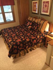 a bed in a bedroom with a blanket on it at High Point Inn in Ephraim