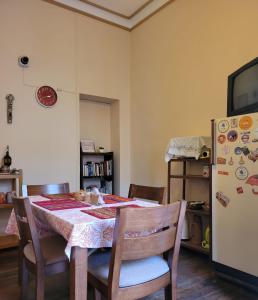 a dining room with a table and a refrigerator at Inka Roots Hostel in Arequipa