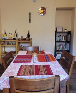 a dining room table with a table cloth on it at Inka Roots Hostel in Arequipa