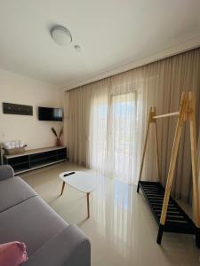 a living room with a couch and a table at Colibri in Kallithea Halkidikis