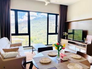 a living room with a table and a large window at Cosy Ins Genting view 2 Bedrooms Home at Geo38 Premier Suites with 100mpbs WiFi available in Genting Highlands