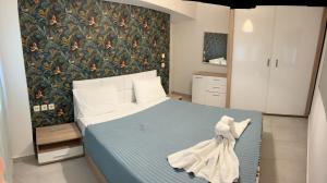 a bedroom with a bed with a dress on it at Irida House in Skala Kallirachis