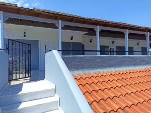 a house with an orange roof and a gate at Seven Seas Apartments in Artemida