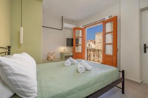 a bedroom with a bed with towels on it at Casa Della vita Loft ,Rhodes Old town in Rhodes Town