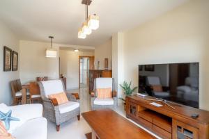 salon z kanapą i telewizorem w obiekcie Cala de Nerja Seaview Casasol w mieście Nerja
