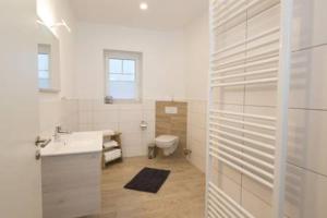 a bathroom with a sink and a toilet at Fewo Obsthof Matthies in Jork +48 photos