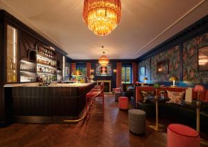 a bar at a restaurant with a chandelier at Cromlix in Kinbuck
