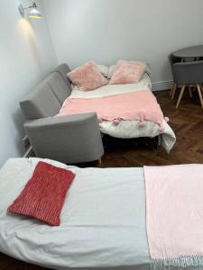 a living room with two beds and a couch at Gorgeous Small House in Brighton in Brighton & Hove