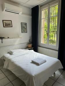 a white bed in a bedroom with a window at Briisa De Ness in Nesso