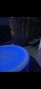 a large blue swimming pool in a room with lights at Bakoua Bungalow - Jacuzzi in Gros-Morne