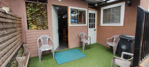 a patio with chairs and a door and a house at EL ROBLE 2.0 CHILLAN in Chillán