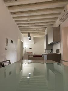 a kitchen with a glass table in a room at Venetian Apartments in Venice
