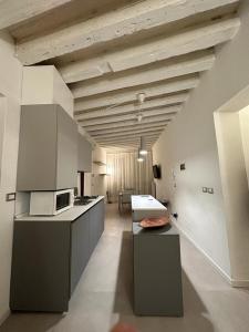 a kitchen with a counter top and a microwave at Venetian Apartments in Venice