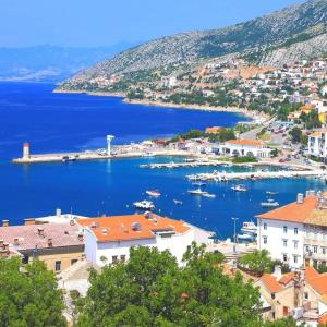 a view of a town with boats in the water at Apartman David in Senj