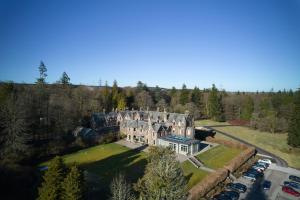an aerial view of a large house with a parking lot at Cromlix in Kinbuck