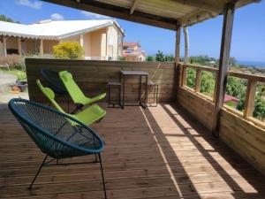 eine Terrasse mit zwei Stühlen und einem Tisch darauf in der Unterkunft Gîte Morne Vent in Bois Neuf