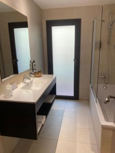 a bathroom with a sink and a shower and a mirror at Petit Palau - Adults Only in Blanes