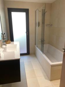 a bathroom with a shower and a tub and a sink at Petit Palau - Adults Only in Blanes