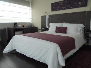 Voodi või voodid majutusasutuse Hotel bh El Poblado toas