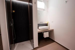 a bathroom with a sink and a shower at La Corte del Fante in Marsala +91 photos
