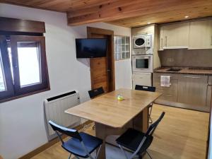 a kitchen with a table and chairs in a room at APARTAMENTO HORIZONTE in Llanes