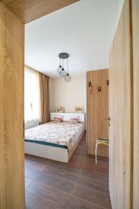 a bedroom with a bed and a sliding door at MARSY in Sandanski