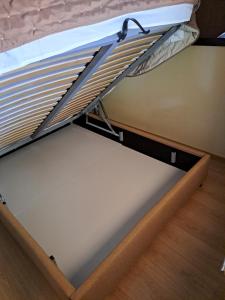 a drawer in a bed with a mattress at Little House Ligia in Lygia