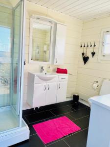 uma casa de banho com um lavatório e um espelho em Summer cabin by the sea Holmsbu. (40 min from Oslo) em Asker