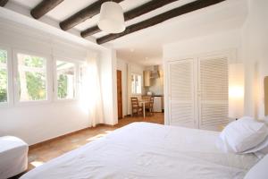 a bedroom with a large white bed in a room at Cortijo La Saleta Banús in Marbella