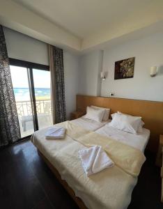 a bedroom with a large bed with white sheets and a window at sea view house in Marsa Alam City +17 photos