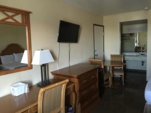 a hotel room with a desk and a bedroom at Motel 6 Henderson NV in Las Vegas