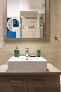 a bathroom with a white sink and a mirror at Apt 6P - Standing RER Tram Paris Orly Velizy in Le Plessis-Robinson