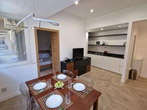 a living room with a table and a kitchen at Casa Camilla in Rome