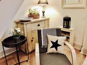 a living room with a star pillow on a chair at Delightful Seaside Binnacle Cottage -hosted by Whitstable-Holidays in Whitstable