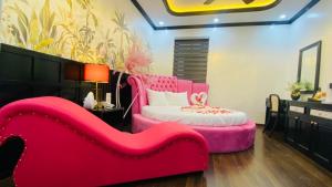 a pink couch and a bed in a room at Thanh Cong Hotel Ha Long in Ha Long +46 photos