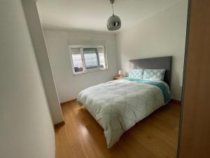 a small bedroom with a bed and a window at Lisbon Spirit (with free parking) in Lisbon